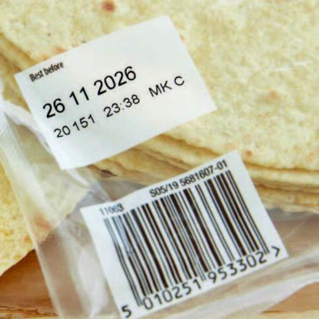 Printed expiry date labels on transparent food packaging plastic